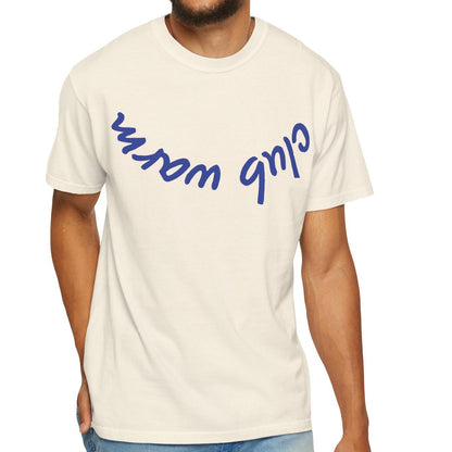 Man wearing a cream t-shirt with blue text on a white background